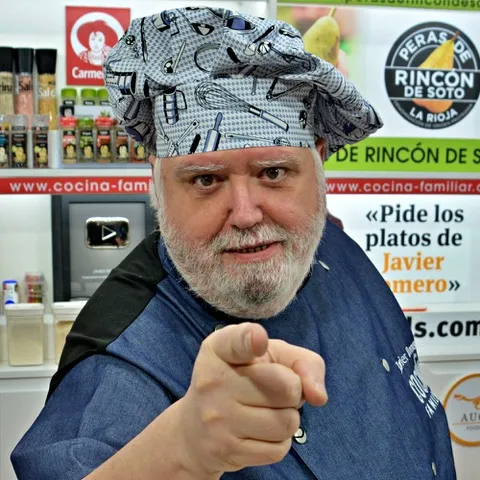 Javier Romero, founder of Cocina Familiar con Javier Romero, points at the camera to encourage his viewers to cook Spanish recipes along with him.